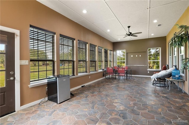 sunroom featuring ceiling fan