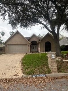 view of front of home with a garage and a front lawn