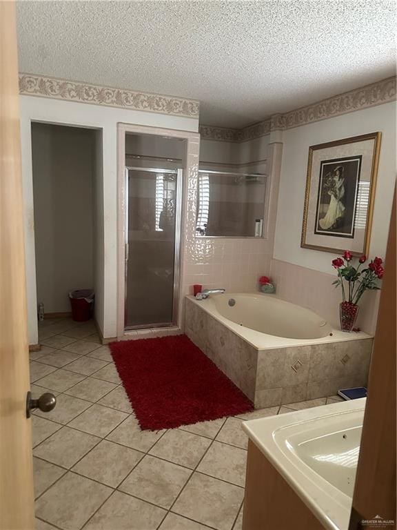 bathroom featuring tile patterned floors, a textured ceiling, and shower with separate bathtub