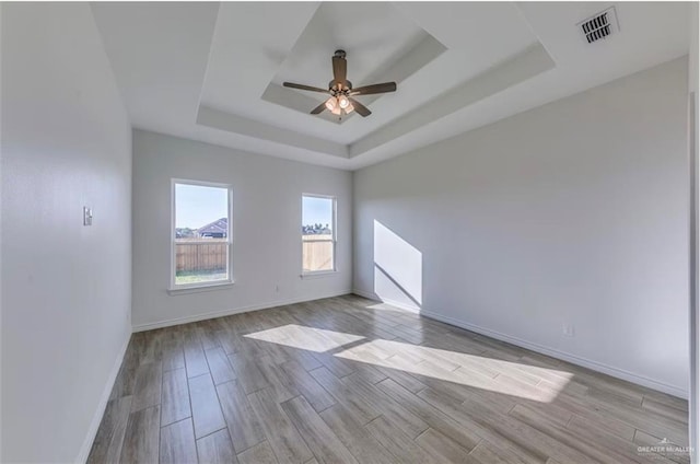 7409 55th St, Mcallen, TX 78573 - unfurnished room with a tray ceiling, ceiling fan, and wood finished floors