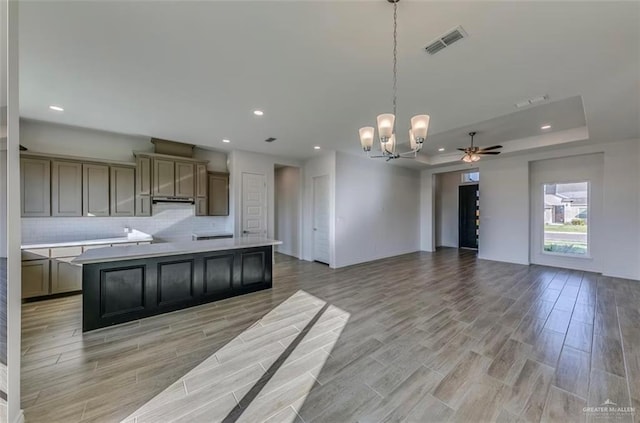 7409 55th St, Mcallen, TX 78573 - kitchen with a chandelier, tasteful backsplash, light wood finished floors, a ceiling fan, and recessed lighting