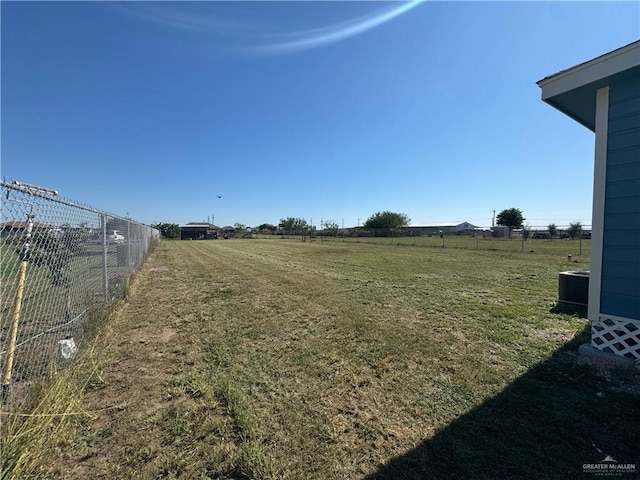 view of yard featuring a rural view and fence