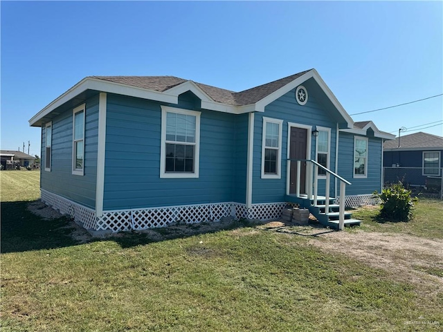 manufactured / mobile home with entry steps and a front yard