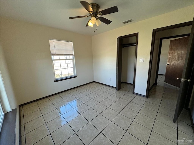 unfurnished bedroom with visible vents, baseboards, and light tile patterned flooring