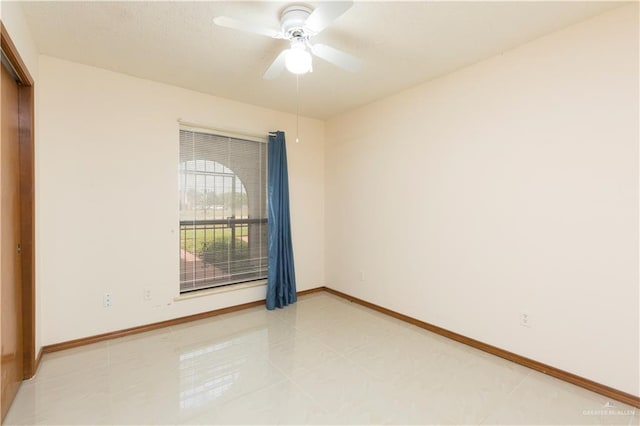 tiled empty room with ceiling fan