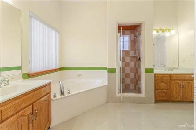 bathroom featuring tile patterned floors, vanity, and shower with separate bathtub