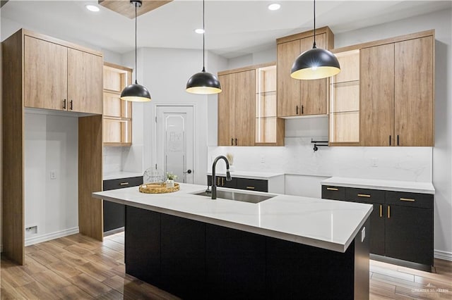 2413 N Woody St, Edinburg, TX 78541 - kitchen featuring decorative backsplash, light wood-style flooring, recessed lighting, hanging light fixtures, and light countertops