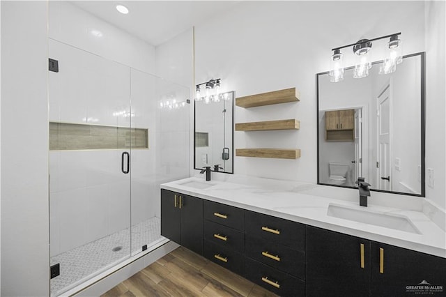 2413 N Woody St, Edinburg, TX 78541 - full bath with double vanity, a stall shower, and wood finished floors