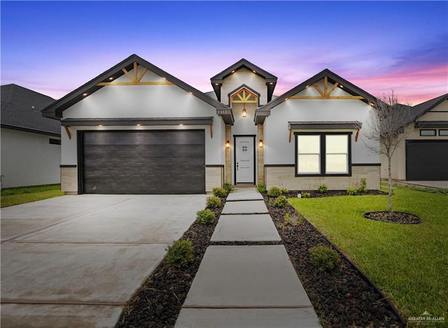 2413 N Woody St, Edinburg, TX 78541 - view of front of home with driveway, an attached garage, a front yard, and stucco siding