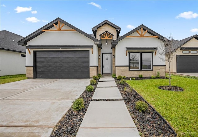 2413 N Woody St, Edinburg, TX 78541 - view of front facade featuring stucco siding, an attached garage, concrete driveway, and a front lawn