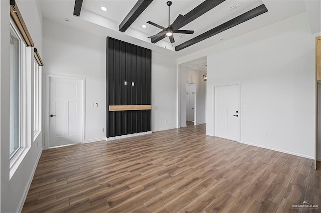 2413 N Woody St, Edinburg, TX 78541 - unfurnished room featuring a ceiling fan, wood finished floors, beam ceiling, a high ceiling, and recessed lighting
