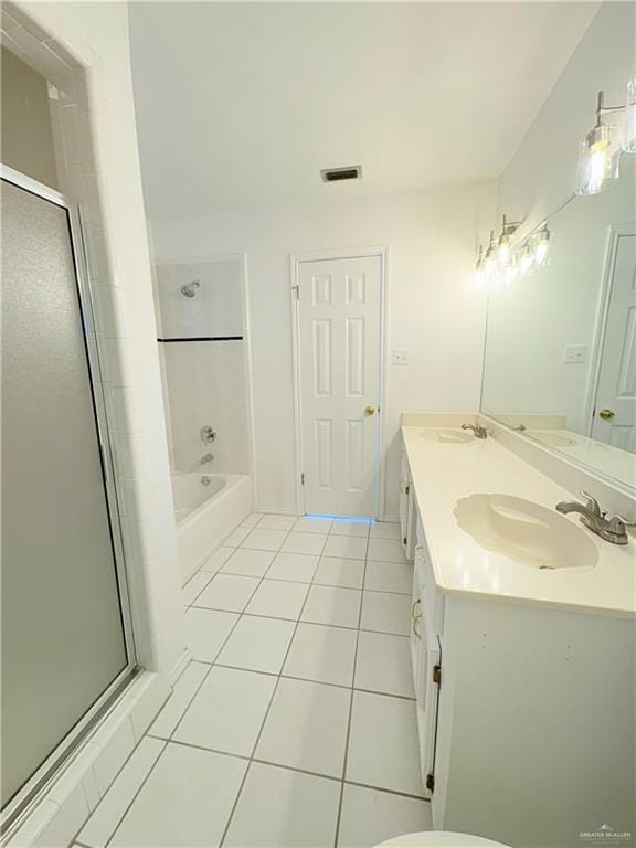 bathroom with tile patterned floors, vanity, and shower with separate bathtub