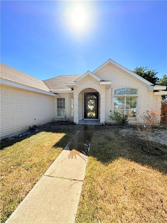 doorway to property featuring a lawn