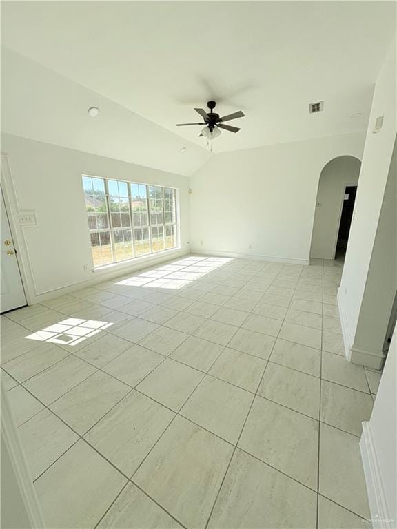 tiled spare room featuring ceiling fan and vaulted ceiling