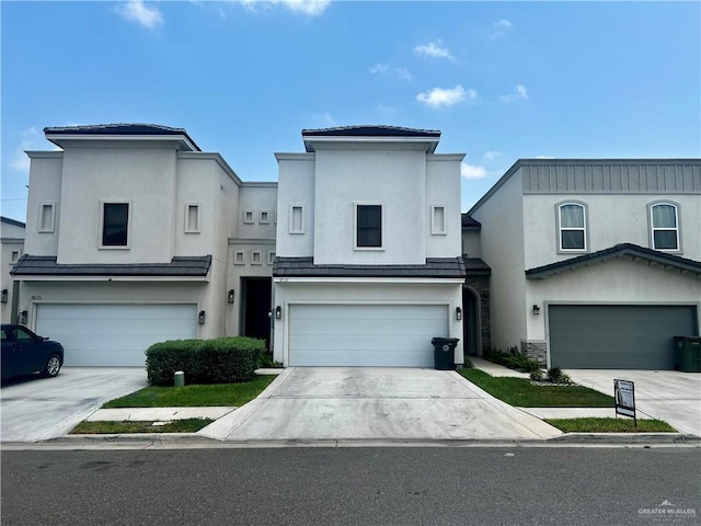1925 Sunset Dr, Mission, TX 78572 - view of front of house with an attached garage, stucco siding, and driveway