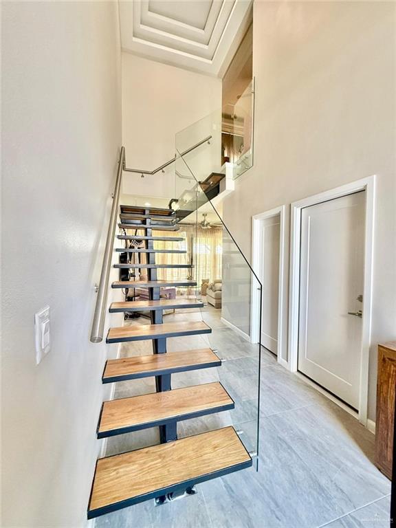 1925 Sunset Dr, Mission, TX 78572 - staircase with a high ceiling and baseboards