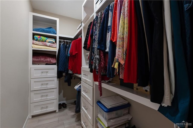 spacious closet with wood finish floors