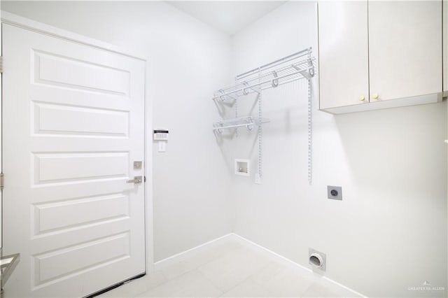 laundry room featuring hookup for an electric dryer, washer hookup, and cabinets