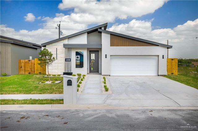 view of front of house featuring a front yard and a garage