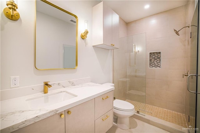 bathroom with vanity, an enclosed shower, and toilet