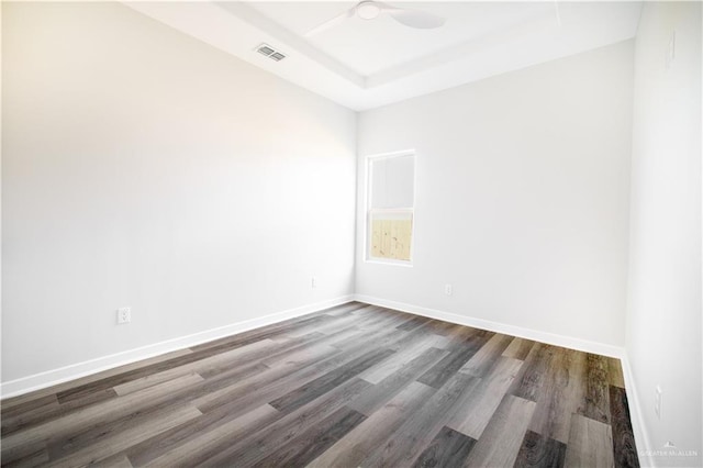 spare room featuring ceiling fan and dark hardwood / wood-style flooring