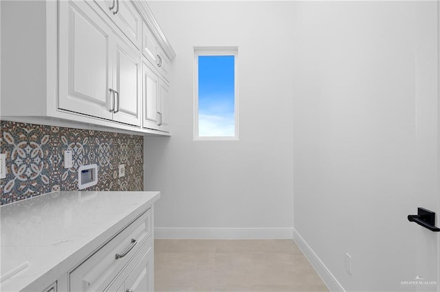 washroom featuring washer hookup and cabinets