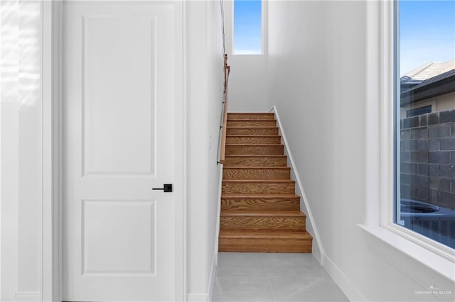 stairs with tile patterned flooring