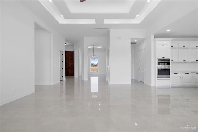 unfurnished living room featuring a raised ceiling