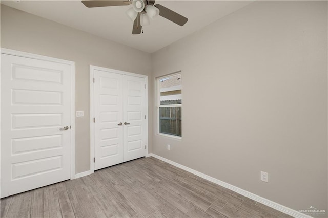 unfurnished bedroom with a closet, ceiling fan, and light wood-type flooring