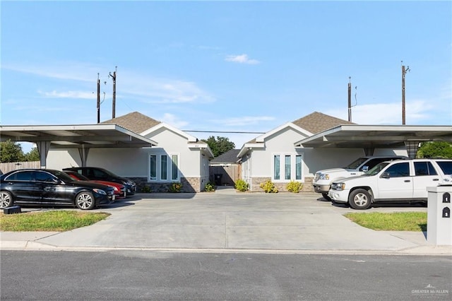 view of parking / parking lot featuring a carport