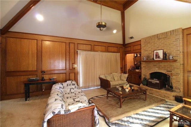living area featuring light carpet, visible vents, a brick fireplace, and beamed ceiling