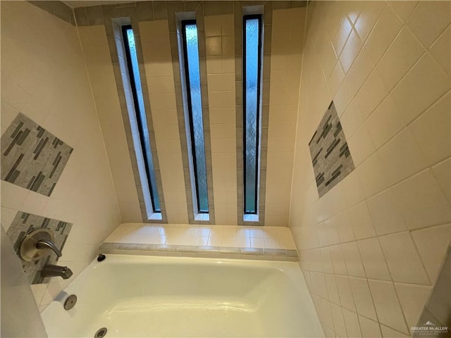 bathroom with tile walls and a washtub