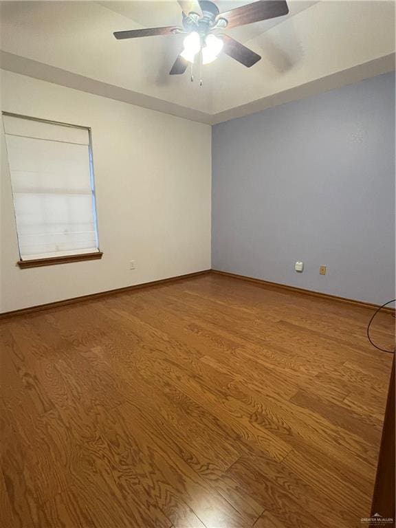 empty room with ceiling fan and hardwood / wood-style floors