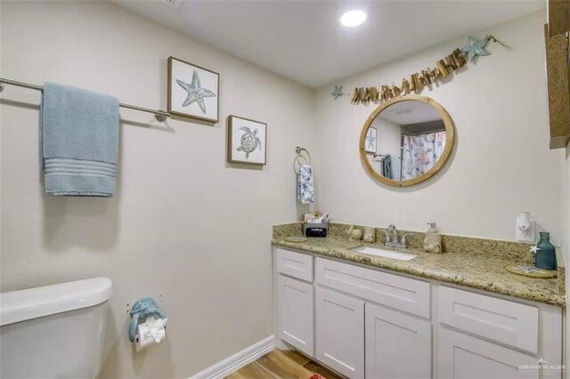 200 Padre Blvd Unit 2102, South Padre Island, TX 78597 - bathroom with vanity, toilet, wood finished floors, and baseboards