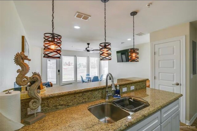 200 Padre Blvd Unit 2102, South Padre Island, TX 78597 - kitchen featuring visible vents, a sink, light stone counters, decorative light fixtures, and recessed lighting
