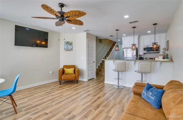 200 Padre Blvd Unit 2102, South Padre Island, TX 78597 - kitchen with visible vents, a peninsula, appliances with stainless steel finishes, pendant lighting, and a kitchen breakfast bar