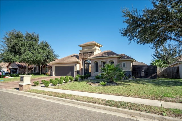 mediterranean / spanish-style home featuring a front yard and a garage