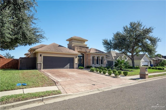 mediterranean / spanish-style house with a garage and a front yard