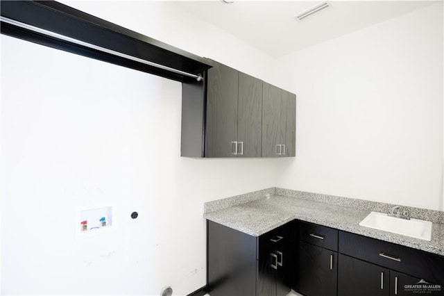 laundry room featuring hookup for a washing machine, sink, and cabinets