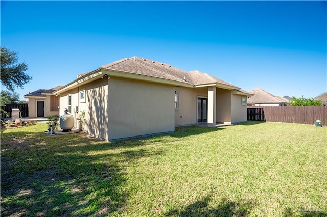 back of house with a lawn