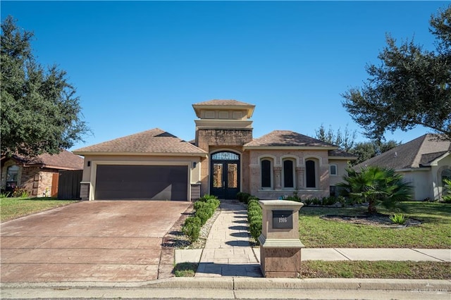 mediterranean / spanish-style home featuring a garage and a front yard