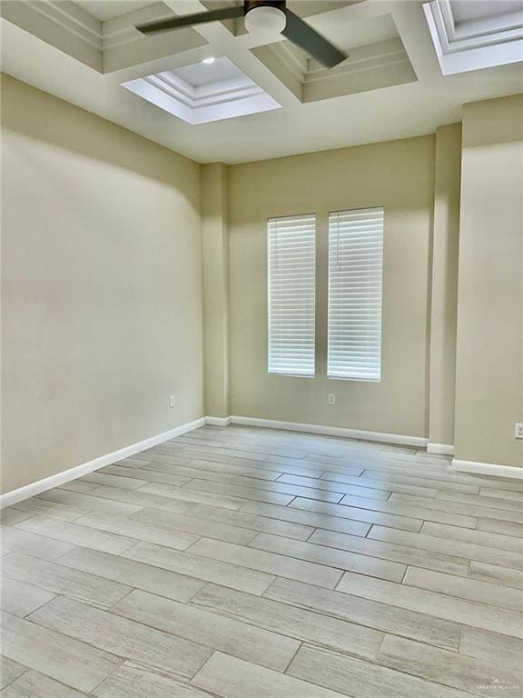 empty room featuring beam ceiling and coffered ceiling