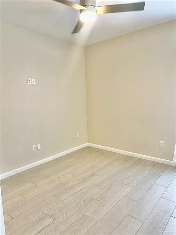 empty room featuring ceiling fan and light hardwood / wood-style flooring