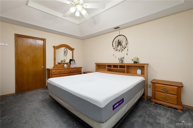 501 Capricorn St, Mission, TX 78572 - bedroom featuring a raised ceiling, dark colored carpet, visible vents, and ceiling fan