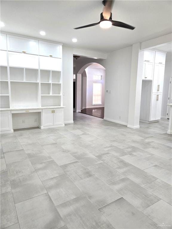 unfurnished living room featuring ceiling fan