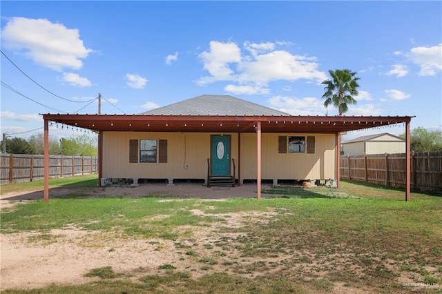 back of property featuring entry steps, a lawn, and fence private yard