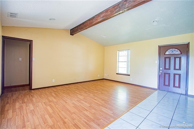 entryway with vaulted ceiling with beams and light hardwood / wood-style floors