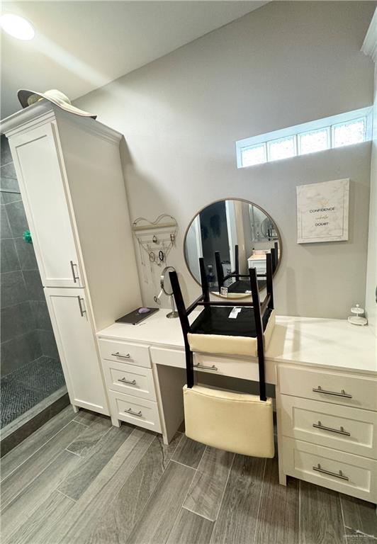 interior space featuring vanity and walk in shower