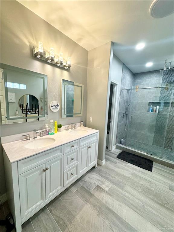 bathroom with vanity and a shower with shower door