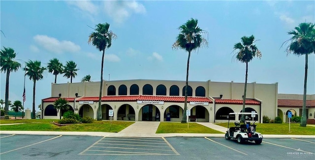 view of building exterior with uncovered parking